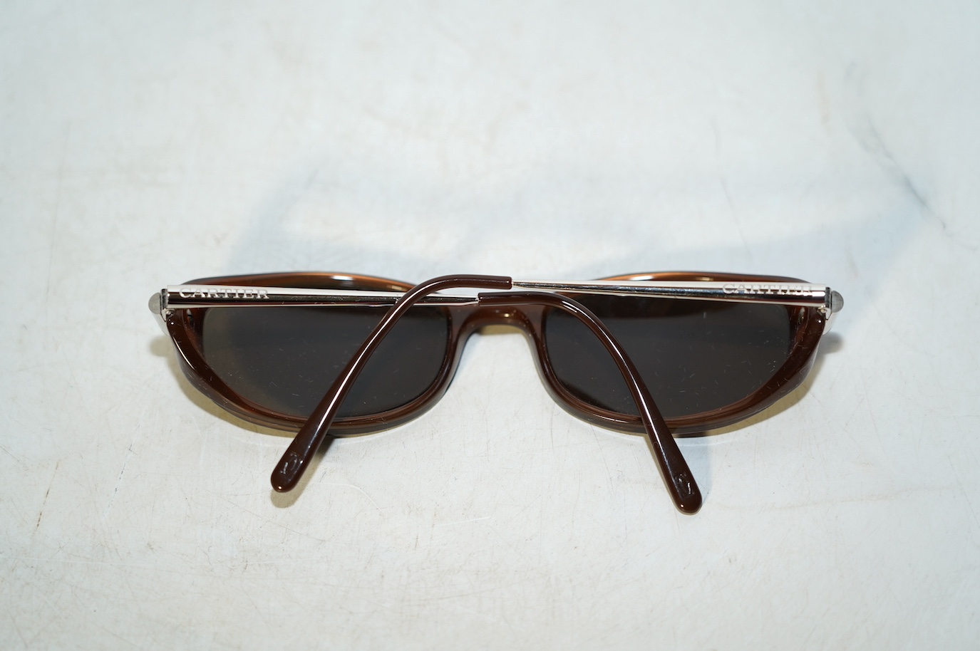 Two pairs of Must de Cartier sunglasses